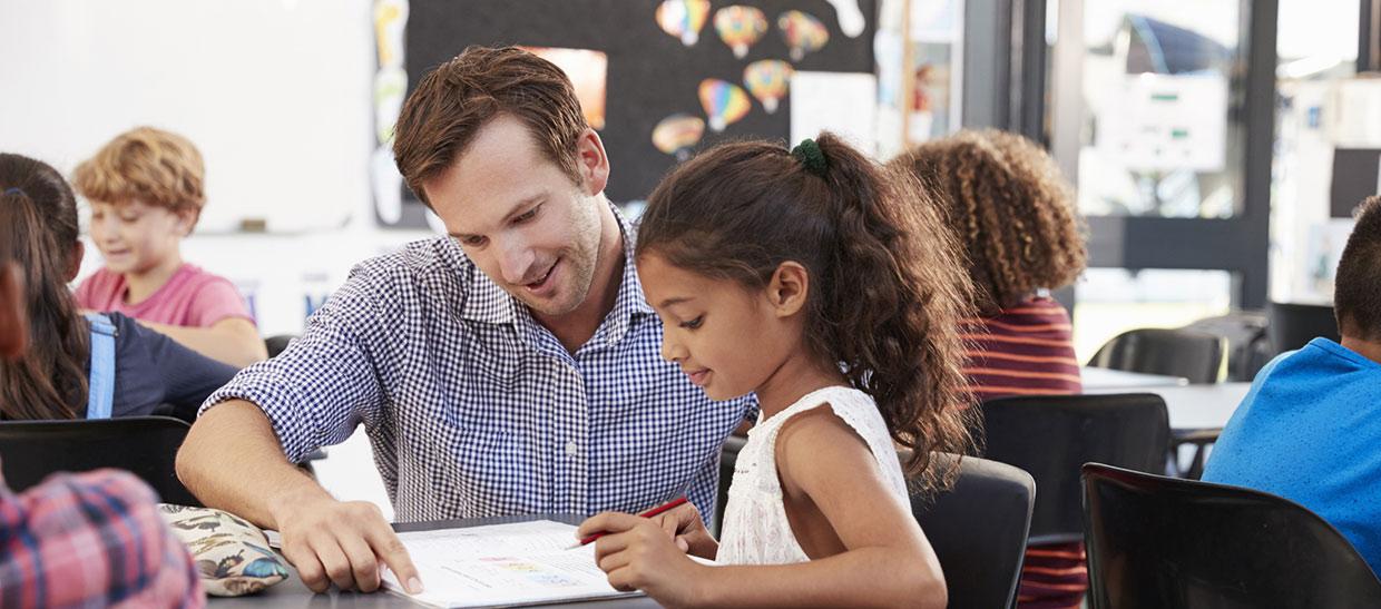 Teacher working with a student in a classroom