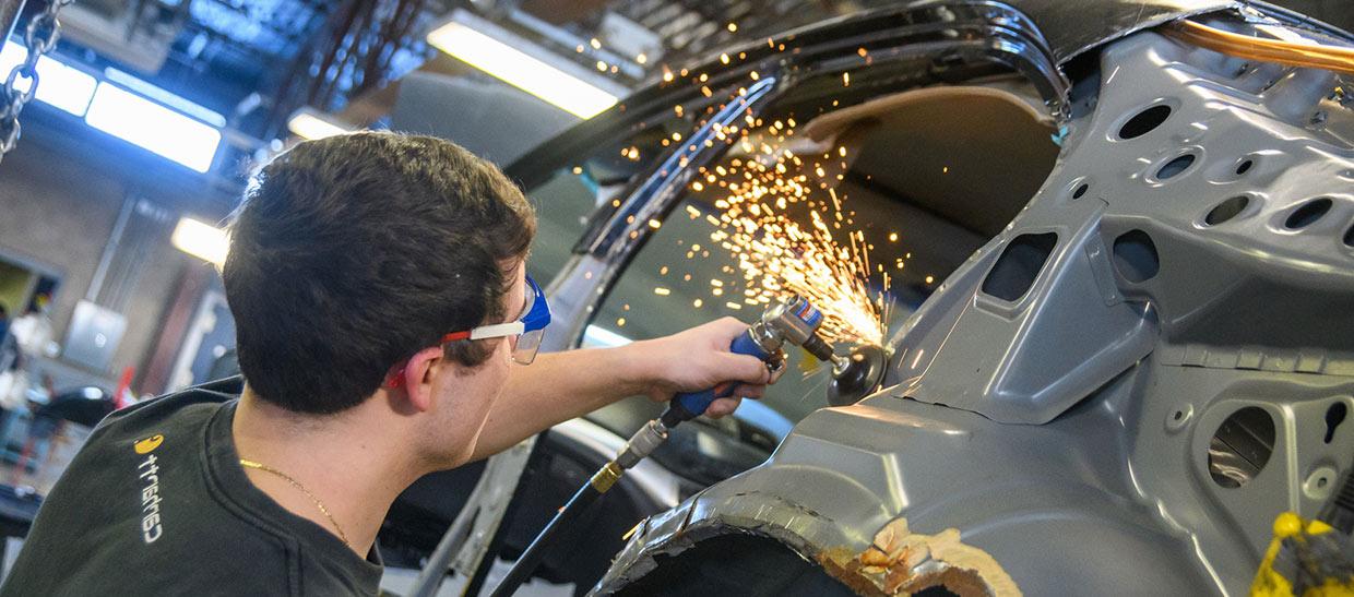 Student welding a piece of metal