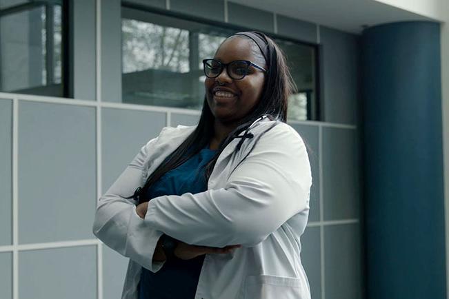 Brianna B. in lab coat smiling